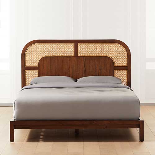 Nadi Cane Queen Bed with natural rattan woven by hand into a geometric pattern on the headboard and a framed midtone wood.