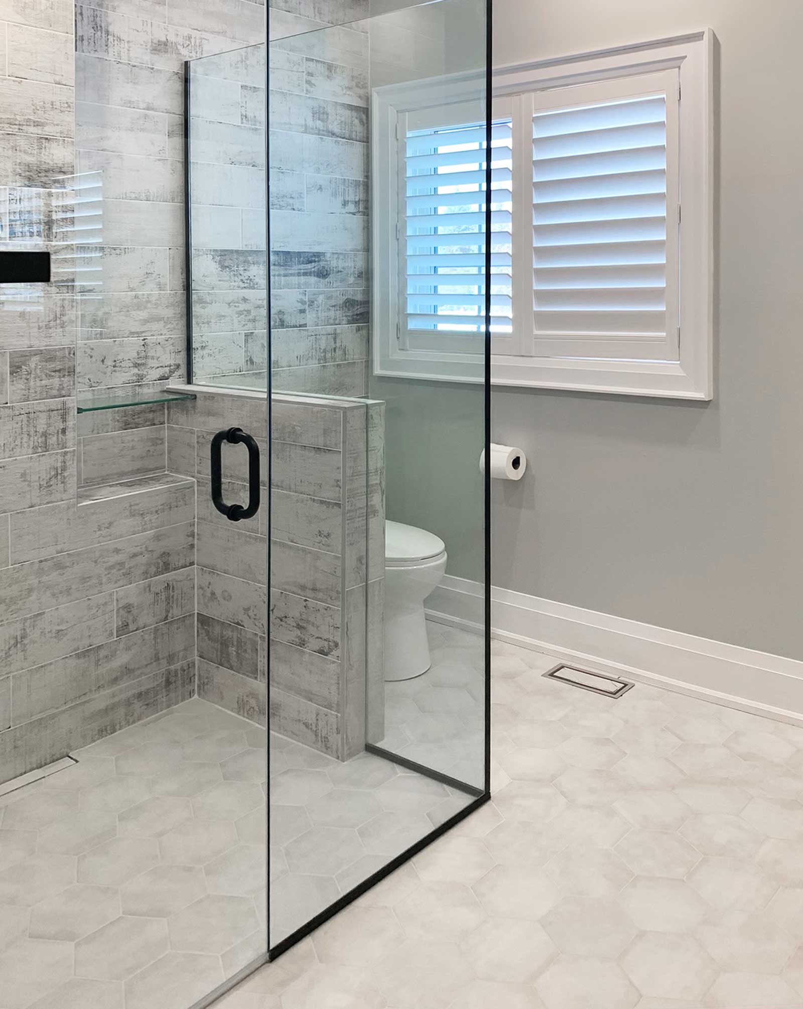 Curbless shower with glass enclosure