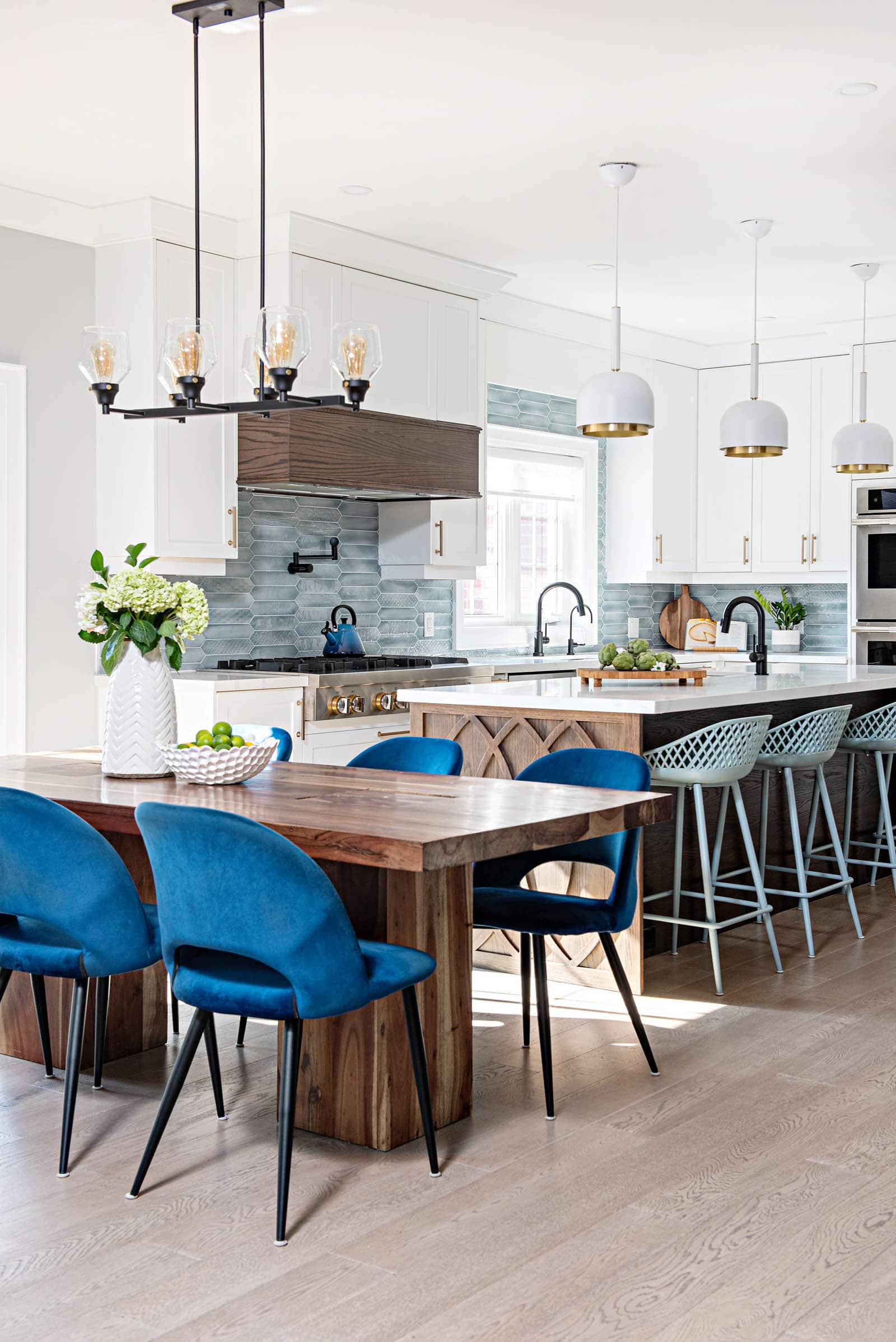 White modern farmhouse kitchen with wood island and blue accents like chairs and tile