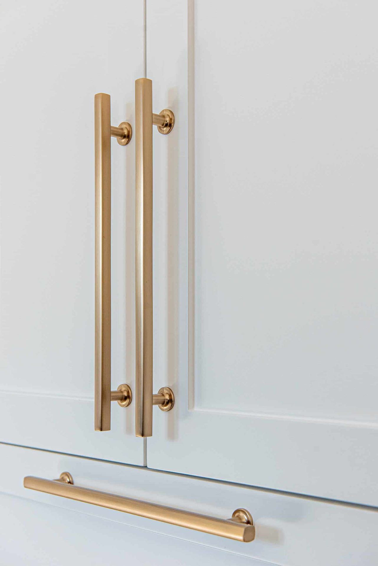 White kitchen cabinets with gold handles