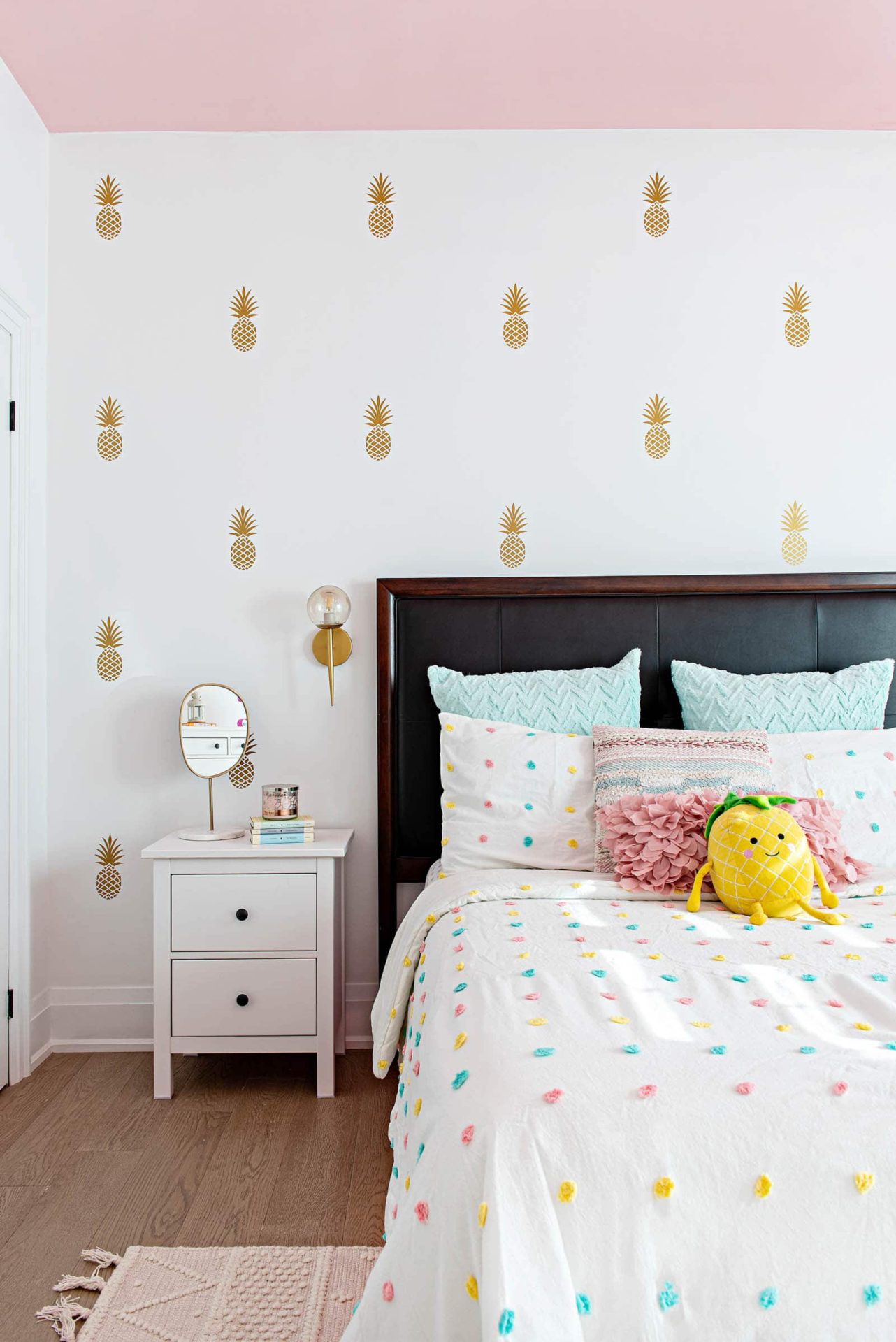 Girls bedroom with pink ceiling and pineapple wall decals