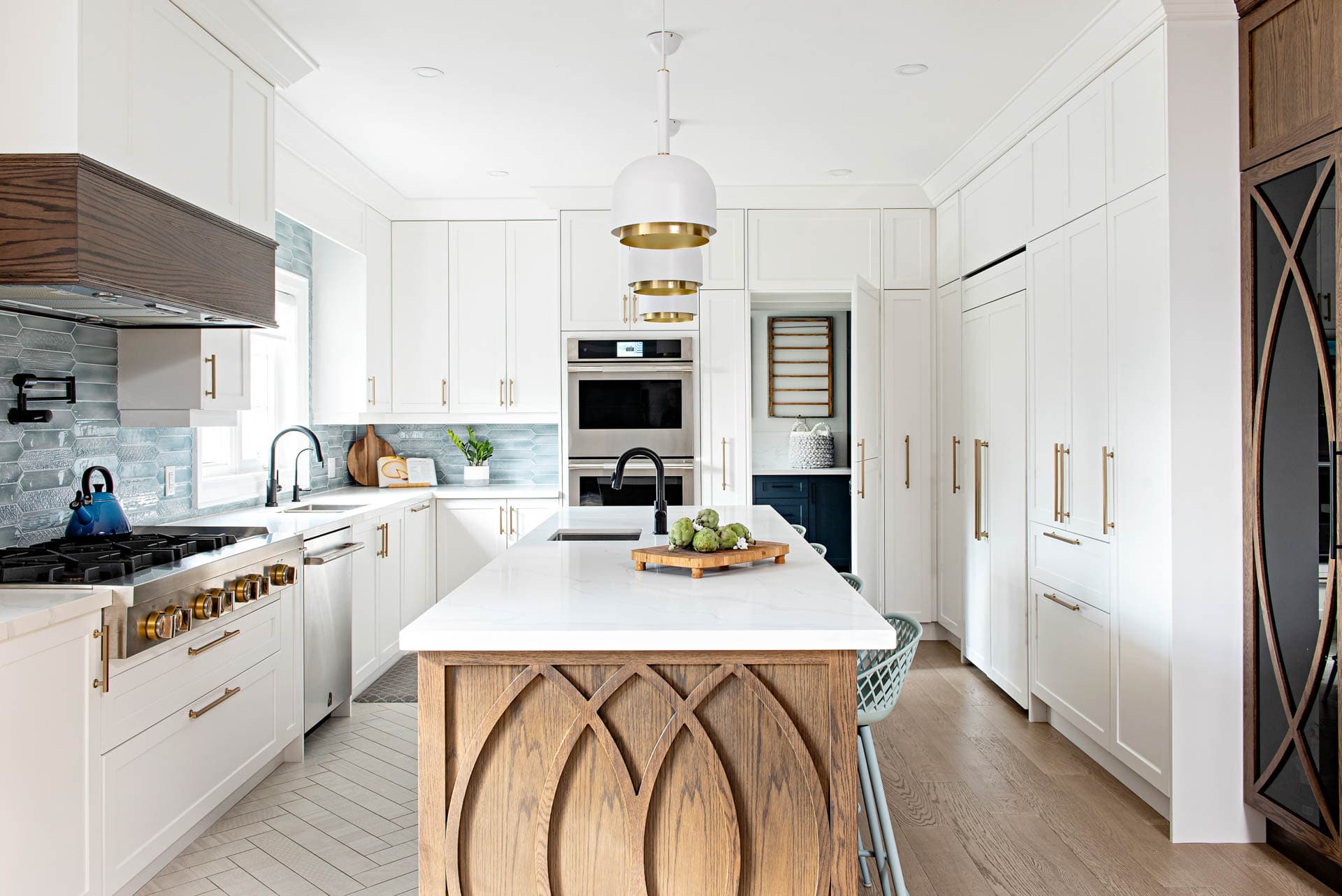 Modern farmhouse white and wood kitchen design with secret laundry door