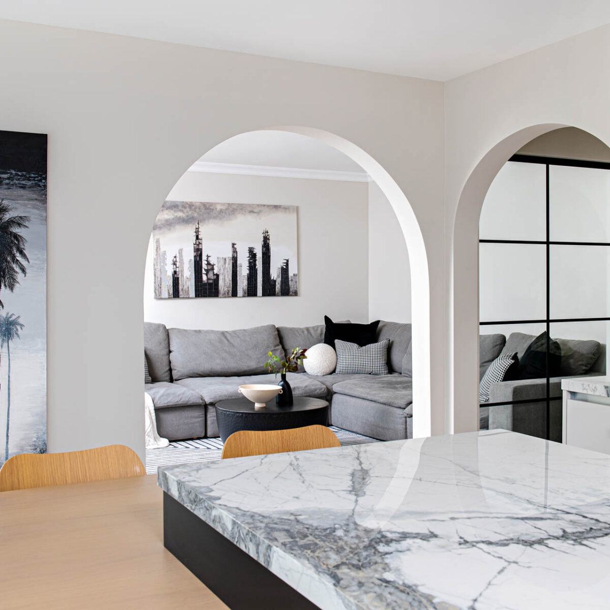 Image of Contemporary kitchen view through the arched opening into the family room.