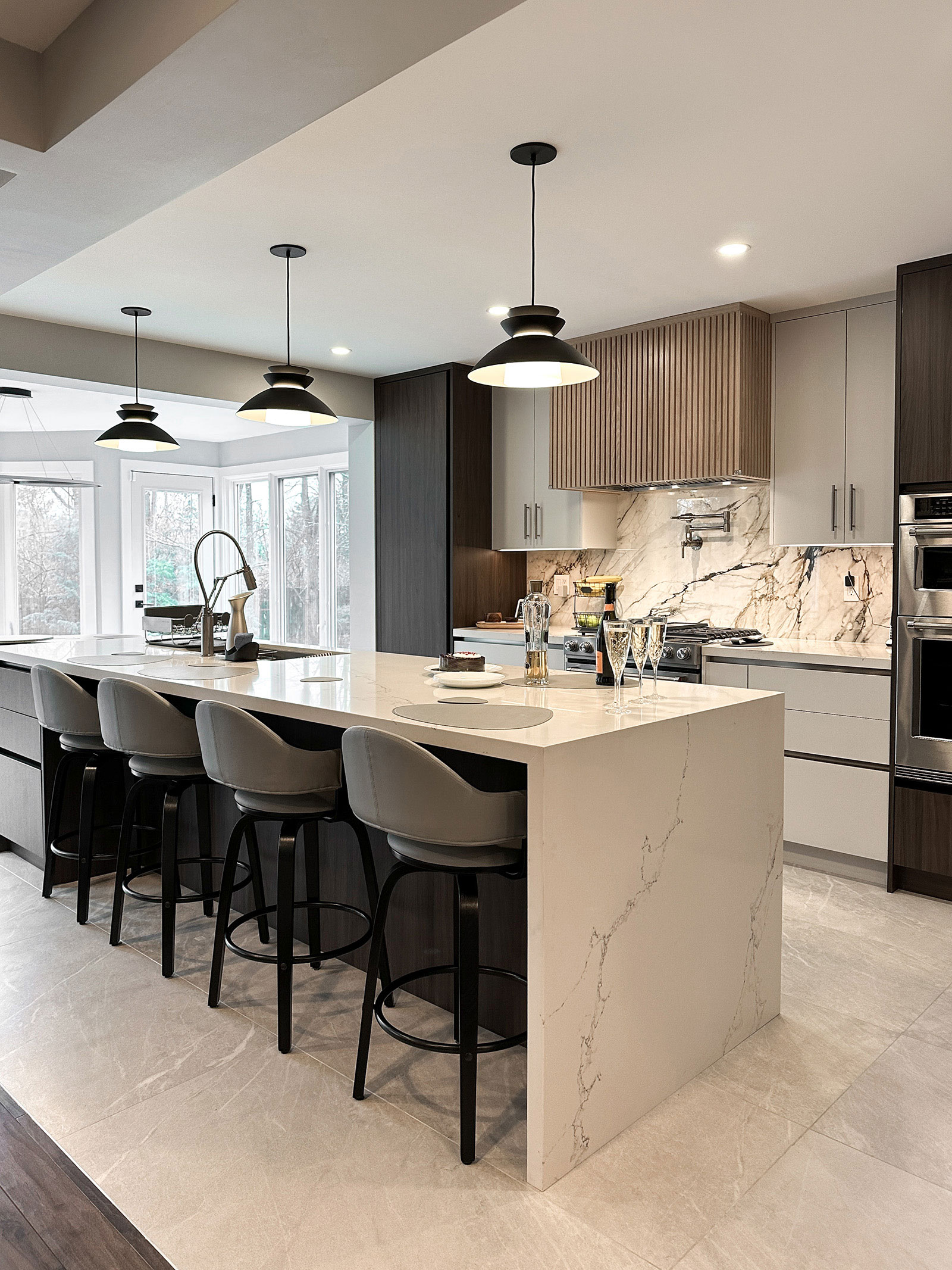 Modern open kitchen with marble island and pendant lights at Bayview Residence